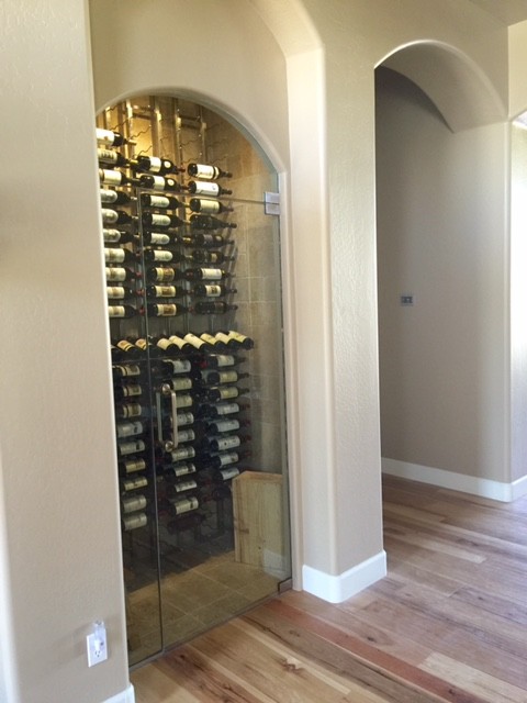 Design ideas for a mid-sized contemporary wine cellar in Phoenix with travertine floors and storage racks.