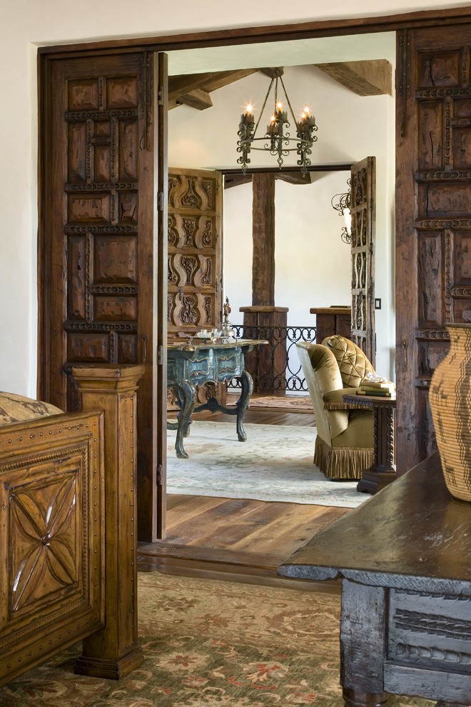 Bedroom - large rustic medium tone wood floor bedroom idea in Other with white walls