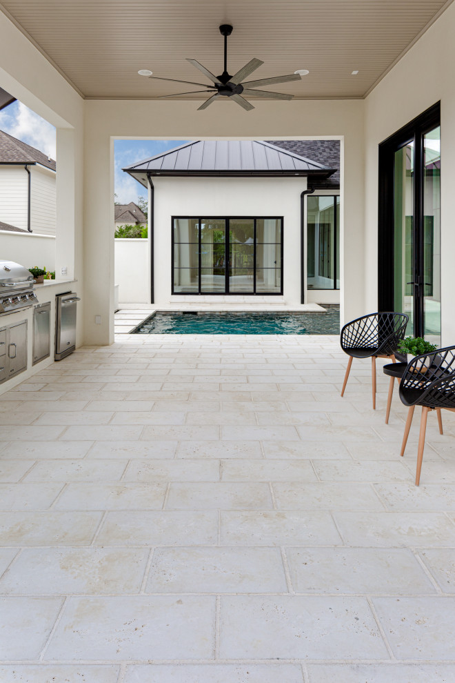 This is an example of a midcentury verandah in New Orleans with concrete pavers.