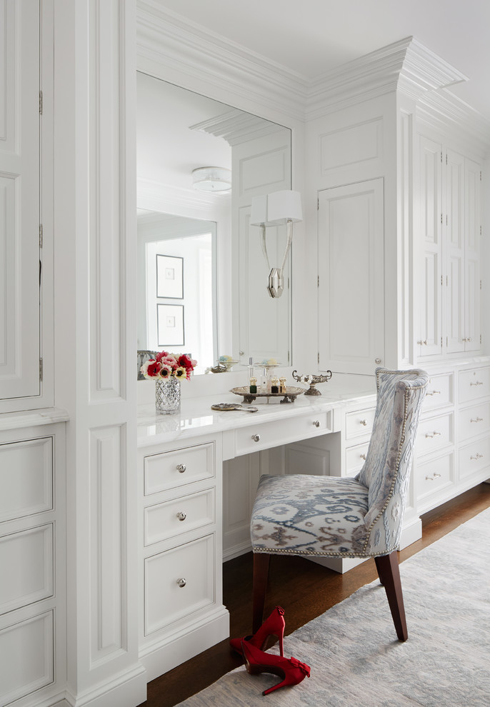 Design ideas for a large traditional women's dressing room in Chicago with beaded inset cabinets, white cabinets and dark hardwood floors.