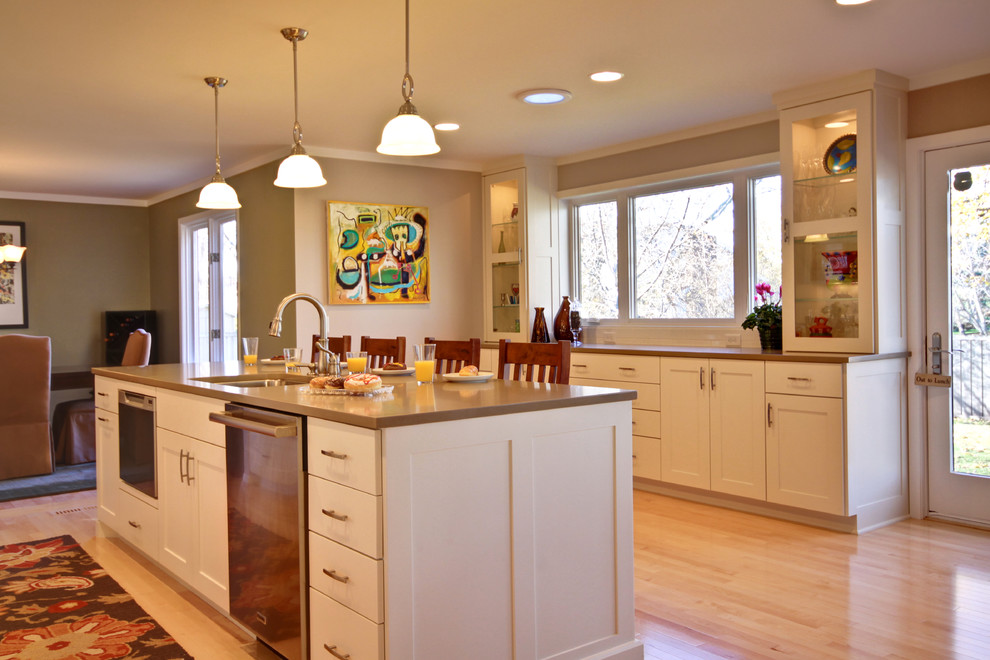 Traditional kitchen in Minneapolis with glass-front cabinets and stainless steel appliances.