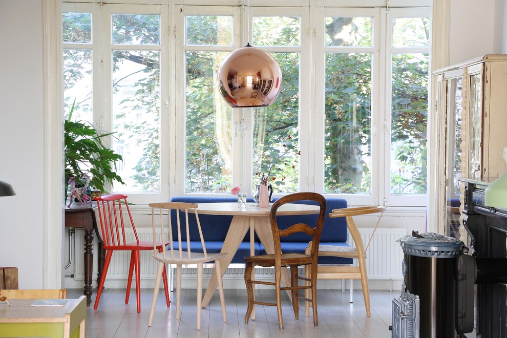 This is an example of a scandinavian dining room in Amsterdam with white walls.