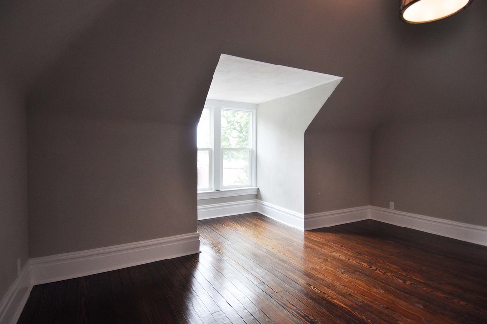 Mid-sized transitional guest bedroom in St Louis with grey walls and medium hardwood floors.