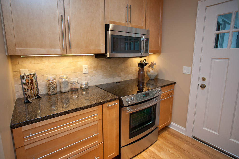 Eat-in kitchen - small transitional galley medium tone wood floor eat-in kitchen idea with an undermount sink, recessed-panel cabinets, light wood cabinets, quartz countertops, beige backsplash, stone tile backsplash, white appliances, beige walls and no island