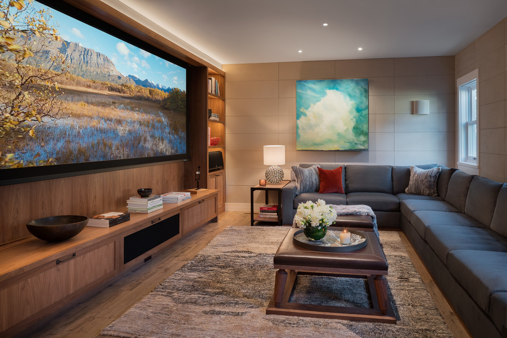 Photo of a mid-sized contemporary enclosed family room in Other with beige walls, light hardwood floors, no fireplace, a built-in media wall and brown floor.