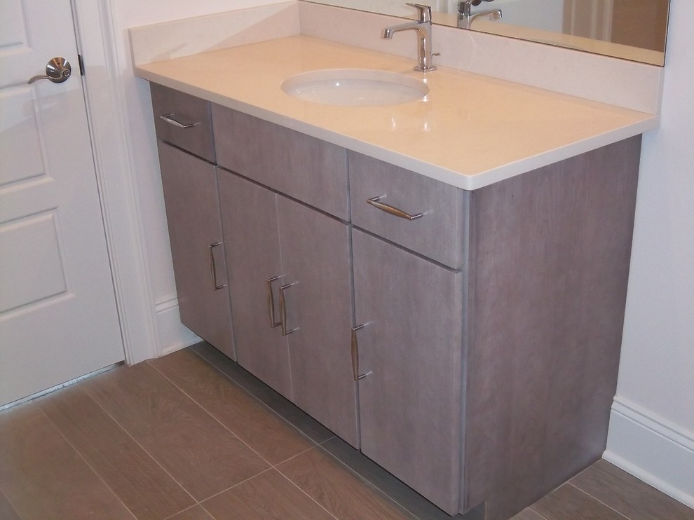 Mid-sized transitional 3/4 porcelain tile and beige floor bathroom photo with flat-panel cabinets, light wood cabinets, white walls, an undermount sink, solid surface countertops and beige countertops