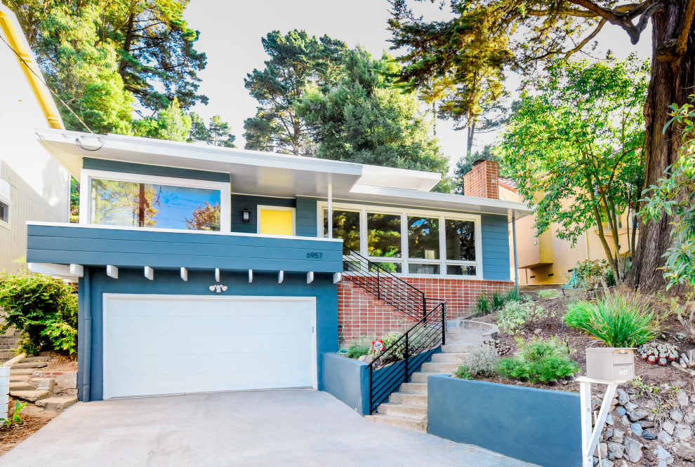 Midcentury blue house exterior in San Francisco with a flat roof.