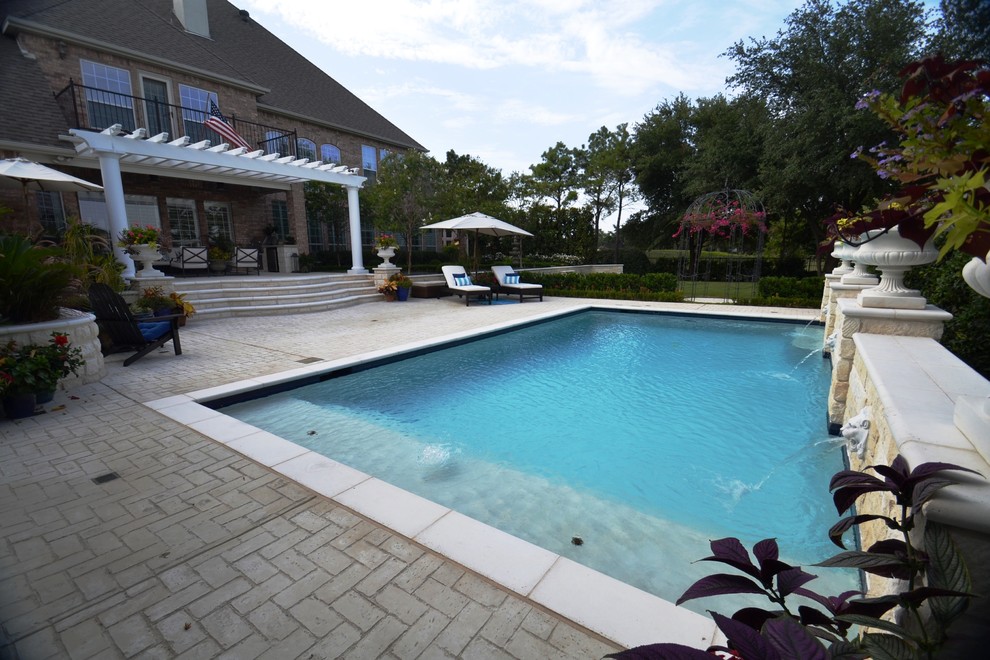 Pool - mid-sized backyard rectangular pool idea in Dallas