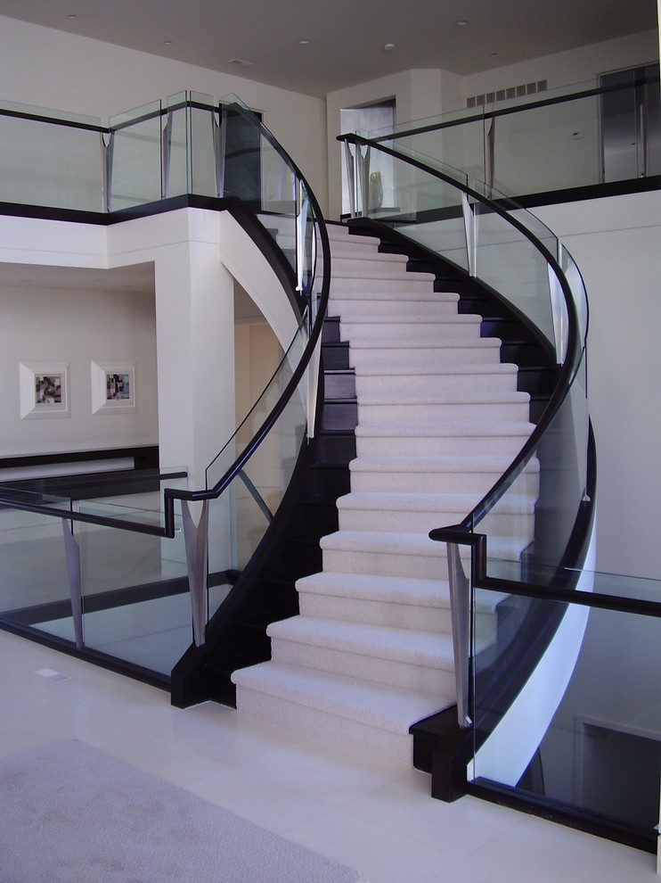 Photo of a mid-sized modern wood curved staircase in Other with wood risers.