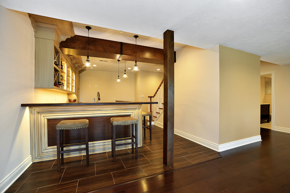 Example of a mid-sized mountain style walk-out basement design with beige walls, a standard fireplace and a stone fireplace