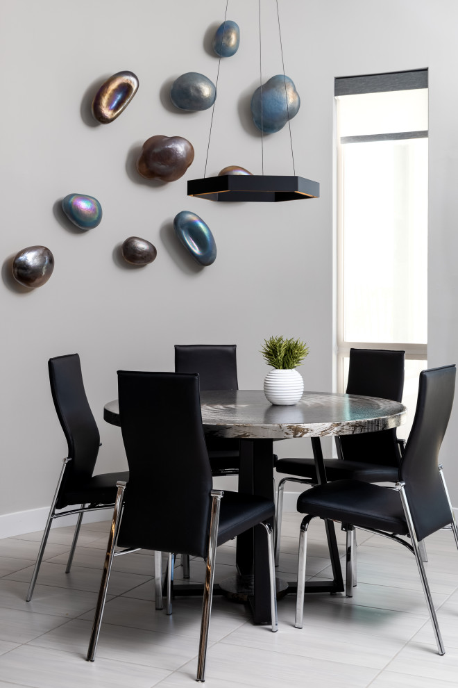 This is an example of a contemporary dining room in Phoenix with grey walls and grey floor.