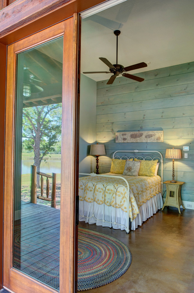 Inspiration for a country bedroom in Houston with concrete floors.