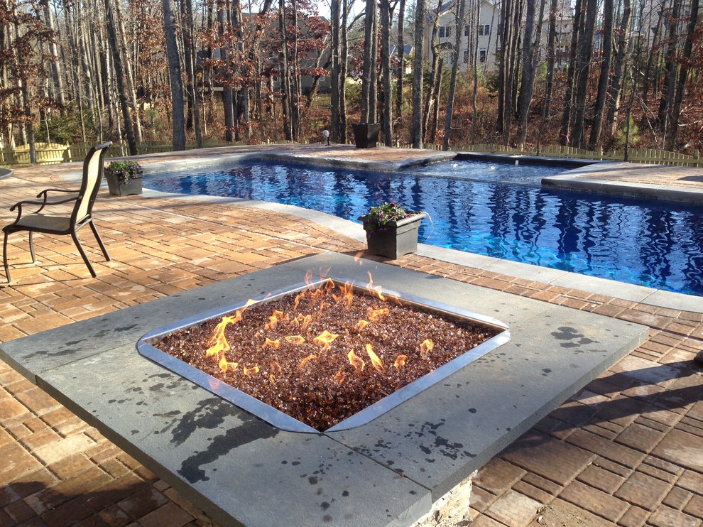 Pool - large rustic backyard concrete paver pool idea in Richmond