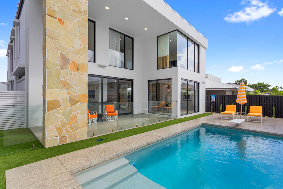 Midcentury backyard rectangular lap pool in Gold Coast - Tweed with natural stone pavers.