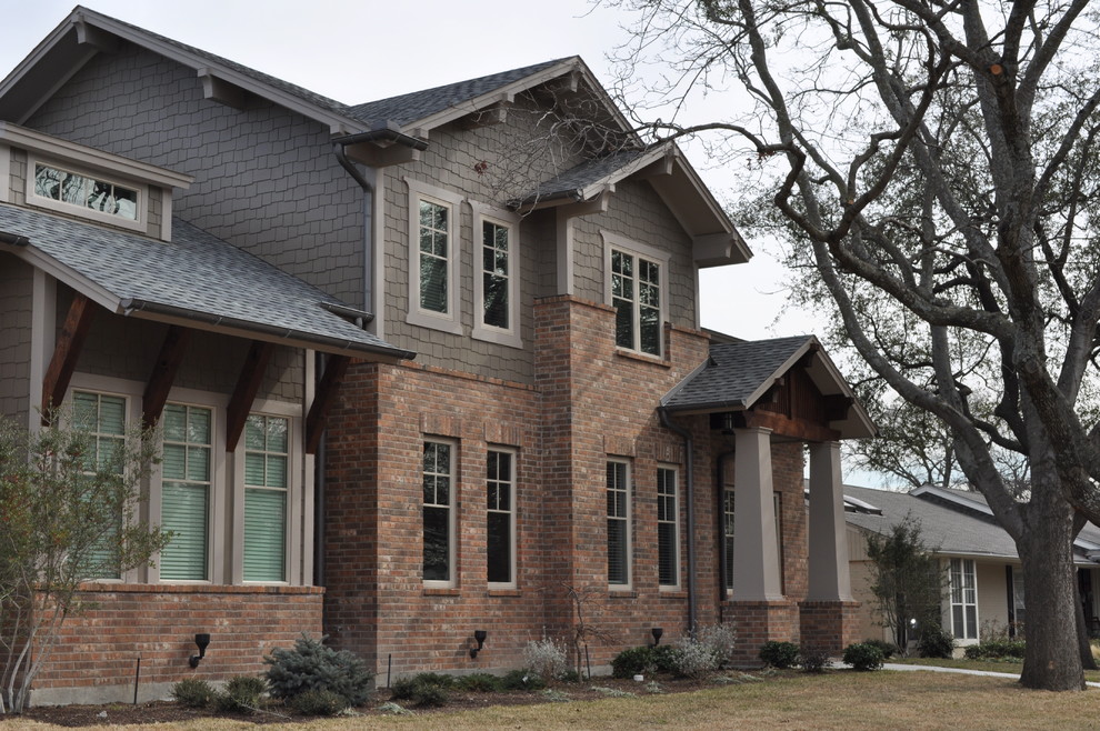 Photo of a large arts and crafts two-storey grey exterior in Dallas with concrete fiberboard siding and a gable roof.