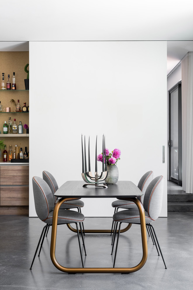 Eclectic open plan dining in Perth with white walls, concrete floors and grey floor.