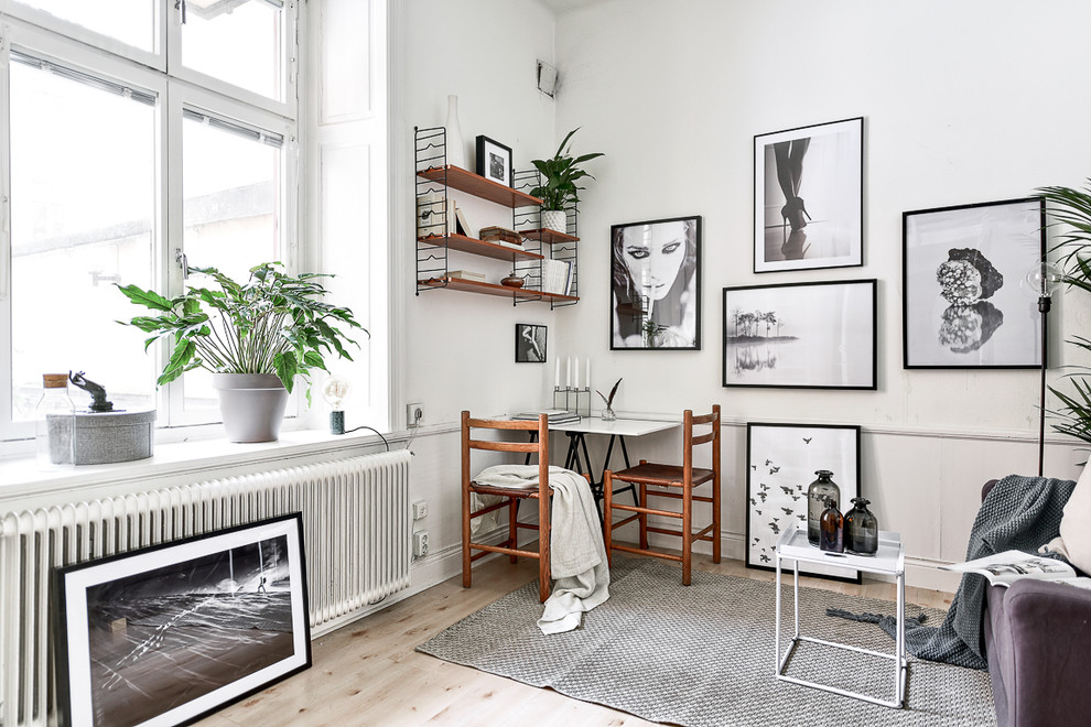 Inspiration for a small scandinavian formal enclosed living room in Stockholm with light hardwood floors, white walls and no tv.
