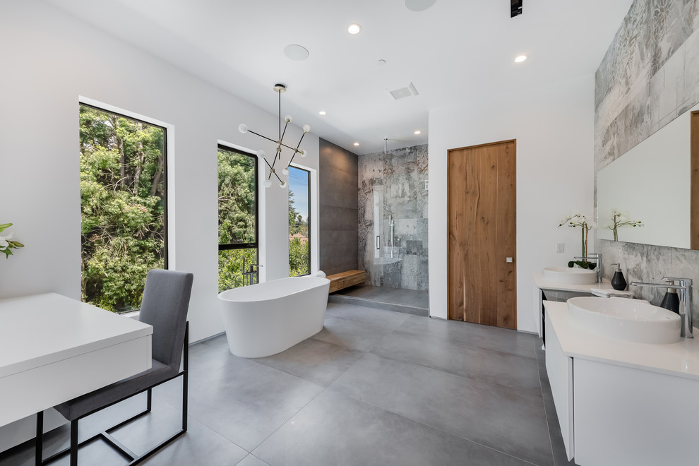 Trendy master gray tile gray floor bathroom photo in Los Angeles with flat-panel cabinets, white cabinets, a vessel sink and white countertops