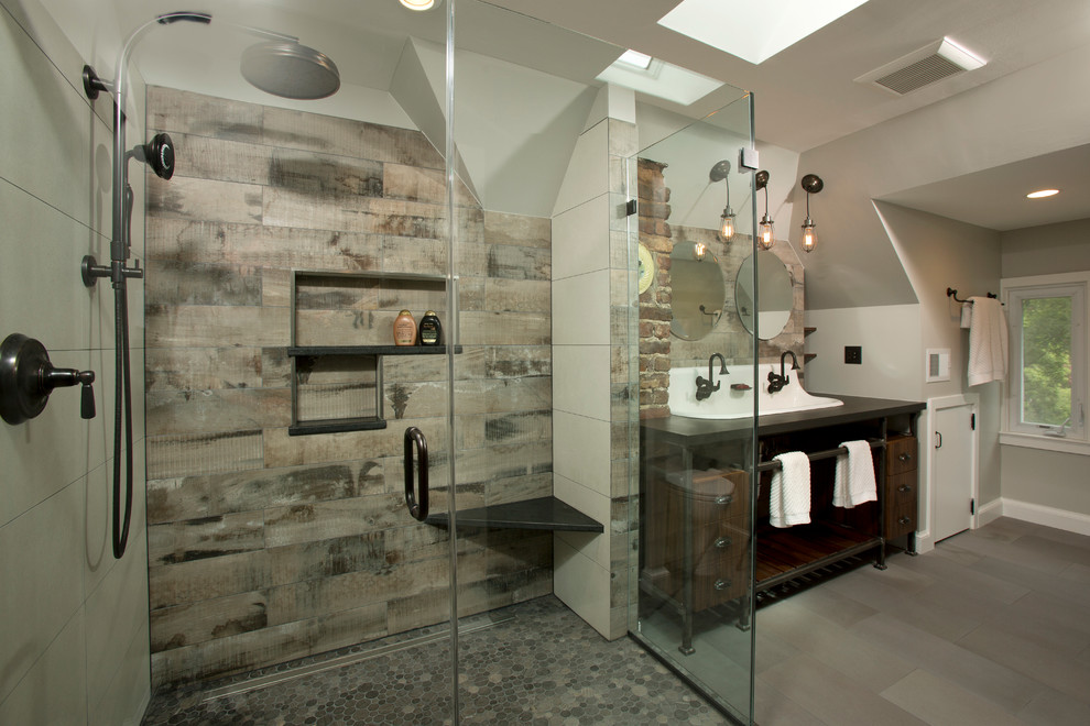 Photo of a large industrial master bathroom in DC Metro with a trough sink, open cabinets, dark wood cabinets, engineered quartz benchtops, a corner shower, a two-piece toilet, gray tile, porcelain tile, porcelain floors and grey walls.