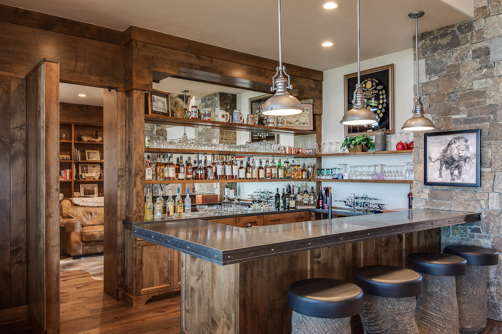 Inspiration for a country u-shaped seated home bar in Other with open cabinets, medium wood cabinets, mirror splashback, medium hardwood floors and grey benchtop.