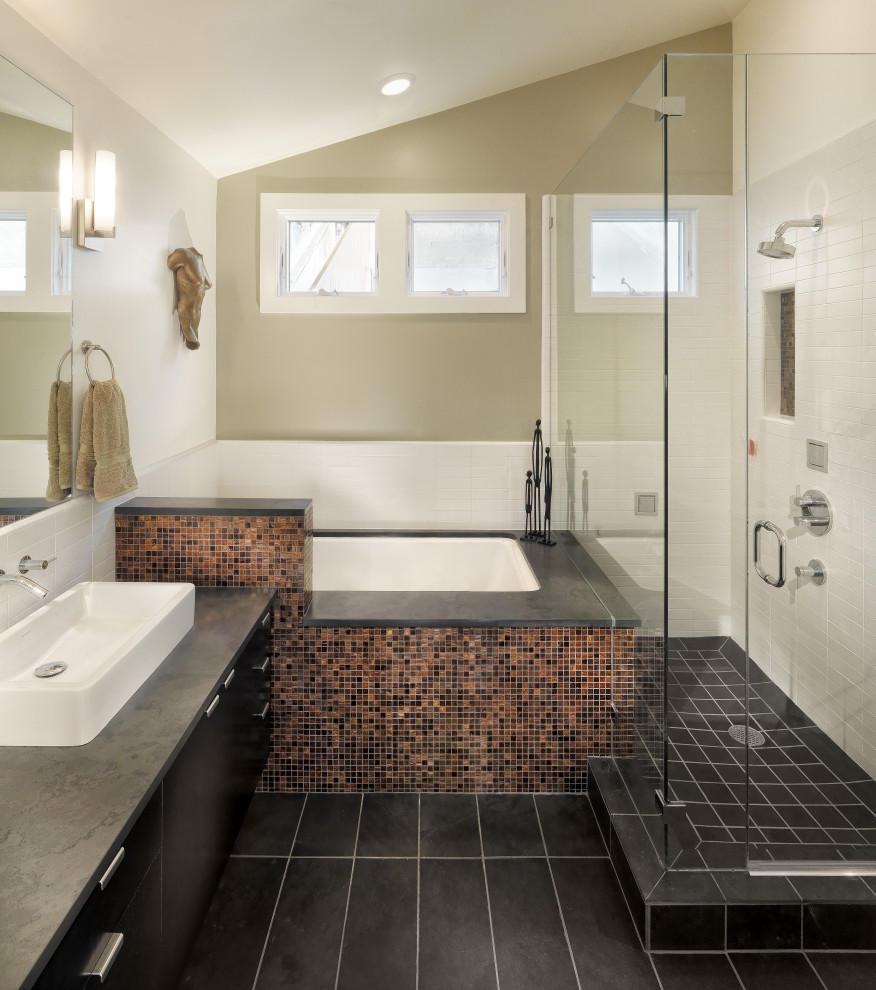 Inspiration for a large contemporary master bathroom in San Francisco with flat-panel cabinets, black cabinets, an undermount tub, a corner shower, white tile, beige walls, porcelain floors, a vessel sink, black floor, a hinged shower door, black benchtops, a niche, a single vanity and a floating vanity.