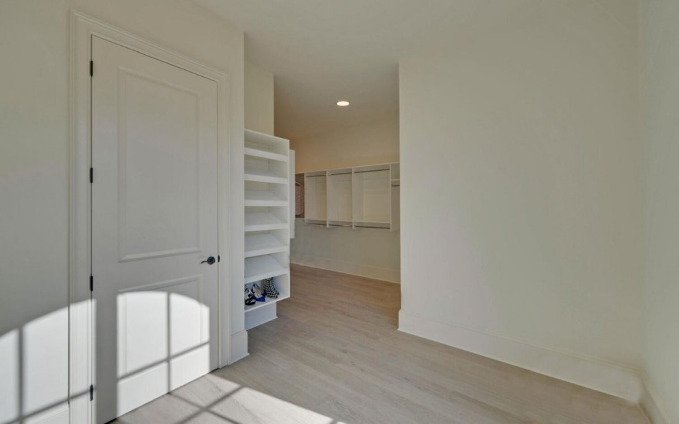 Inspiration for a transitional storage and wardrobe in Atlanta with flat-panel cabinets.