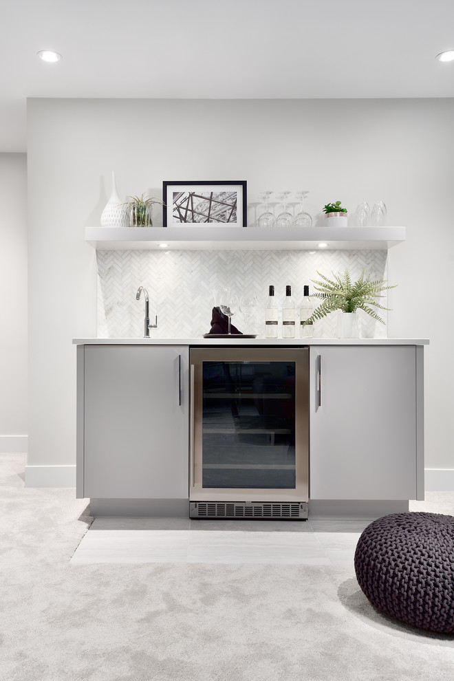 Design ideas for a large contemporary single-wall wet bar in Vancouver with an undermount sink, flat-panel cabinets, grey cabinets, marble benchtops, white splashback, mosaic tile splashback, carpet, grey floor and grey benchtop.