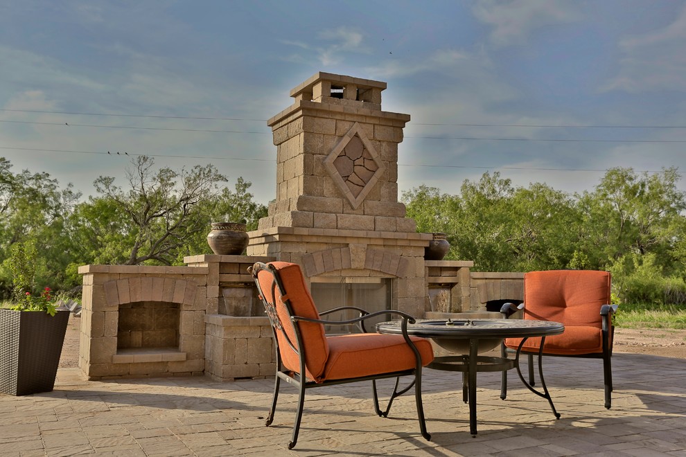 Photo of a mid-sized mediterranean backyard patio in Dallas with a fire feature, concrete pavers and no cover.