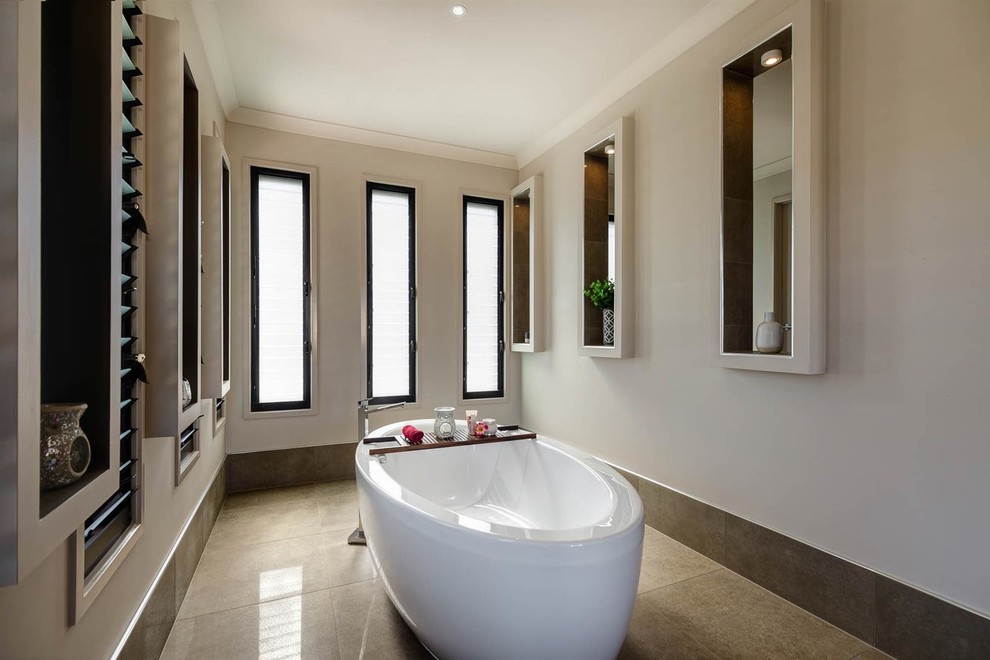 This is an example of an asian bathroom with beige walls and a freestanding tub.