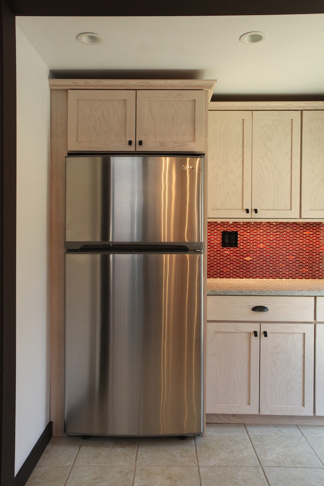 Example of a transitional ceramic tile kitchen design in New York with an undermount sink, shaker cabinets, light wood cabinets, granite countertops, red backsplash, ceramic backsplash and stainless steel appliances