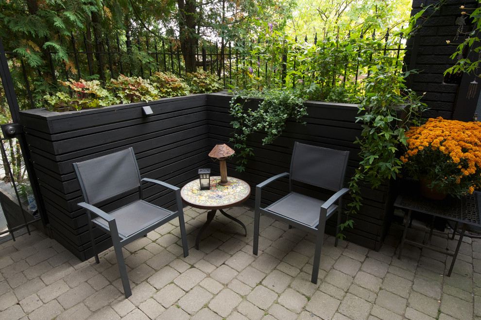 Design ideas for a contemporary patio in Toronto with concrete pavers and no cover.
