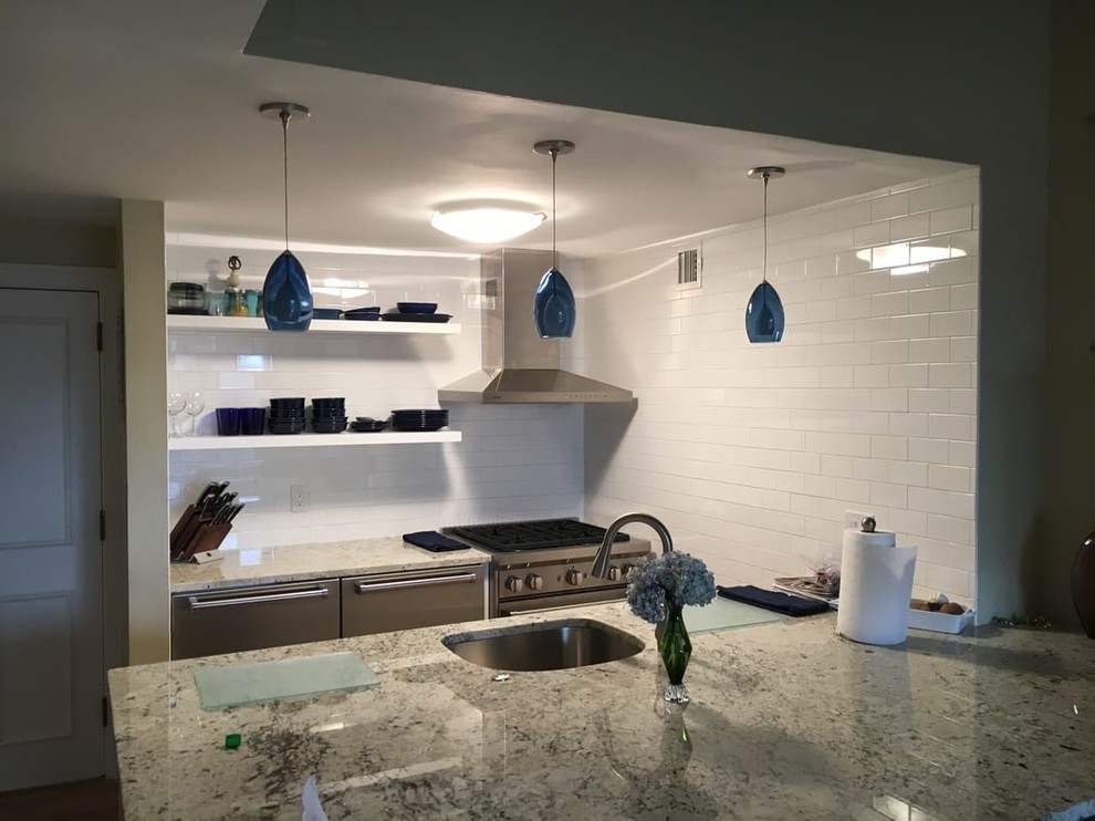 Enclosed kitchen - small transitional galley enclosed kitchen idea in Boston with an undermount sink, open cabinets, white cabinets, granite countertops, white backsplash, subway tile backsplash, stainless steel appliances and a peninsula
