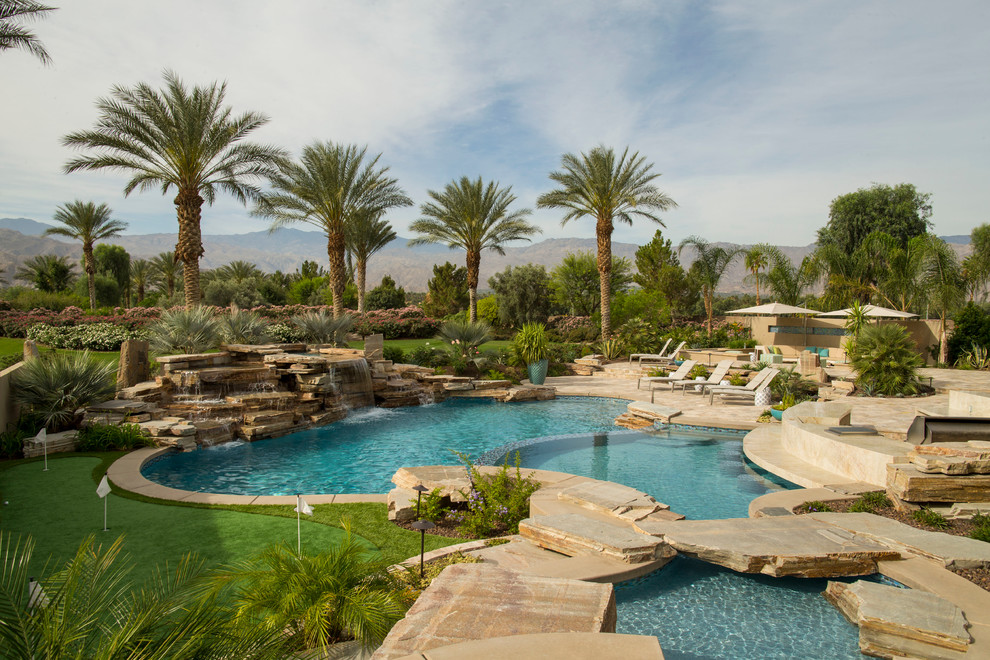 Pool fountain - mid-sized transitional backyard concrete paver and round natural pool fountain idea
