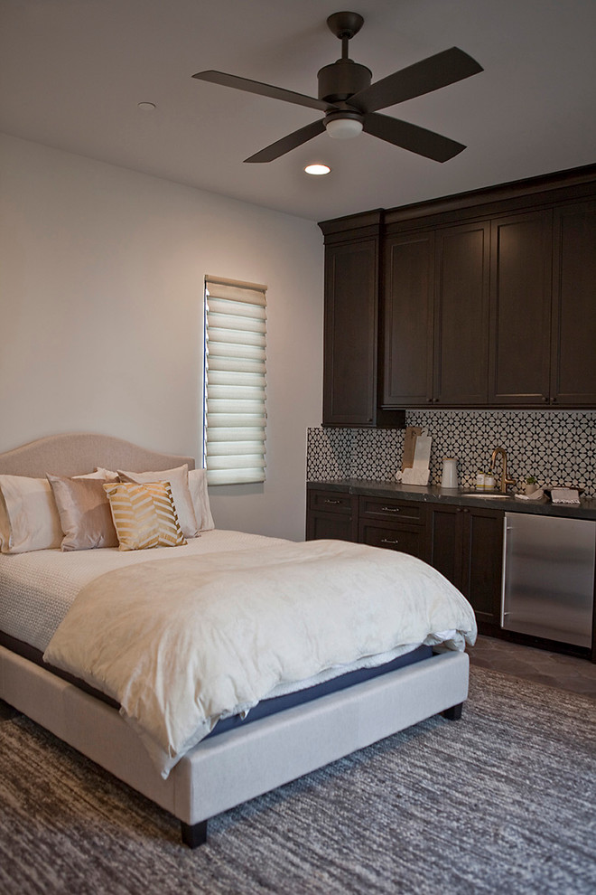 Inspiration for a large transitional guest bedroom in San Diego with white walls and terra-cotta floors.