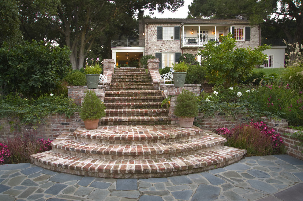 Design ideas for a traditional sloped garden in San Francisco with brick pavers.
