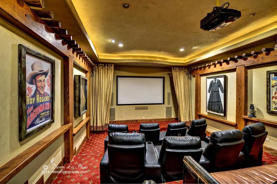 Photo of a mid-sized open concept home theatre in Salt Lake City with beige walls, carpet and a wall-mounted tv.