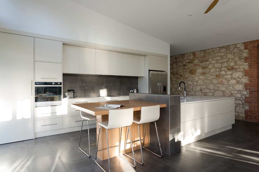 Photo of a large contemporary single-wall eat-in kitchen in Adelaide with a double-bowl sink, solid surface benchtops, ceramic splashback, stainless steel appliances, ceramic floors and with island.