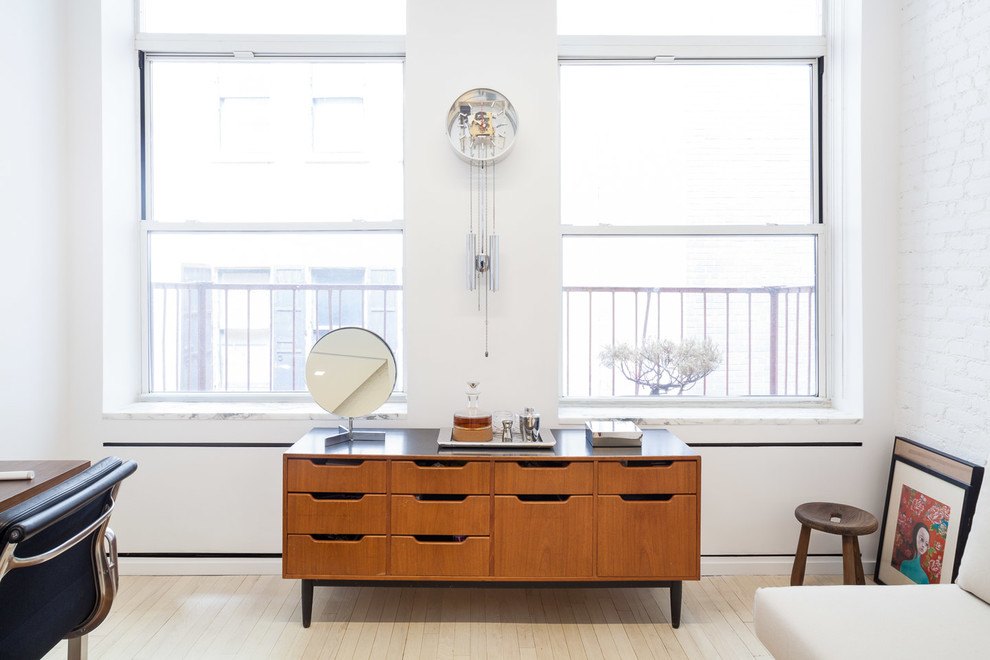 Inspiration for a midcentury guest bedroom in New York with white walls, light hardwood floors and no fireplace.