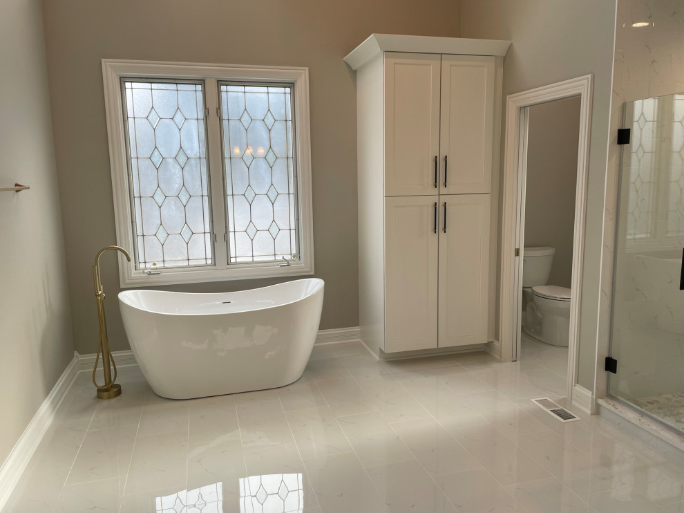Photo of a large transitional master bathroom in Chicago with a freestanding tub.