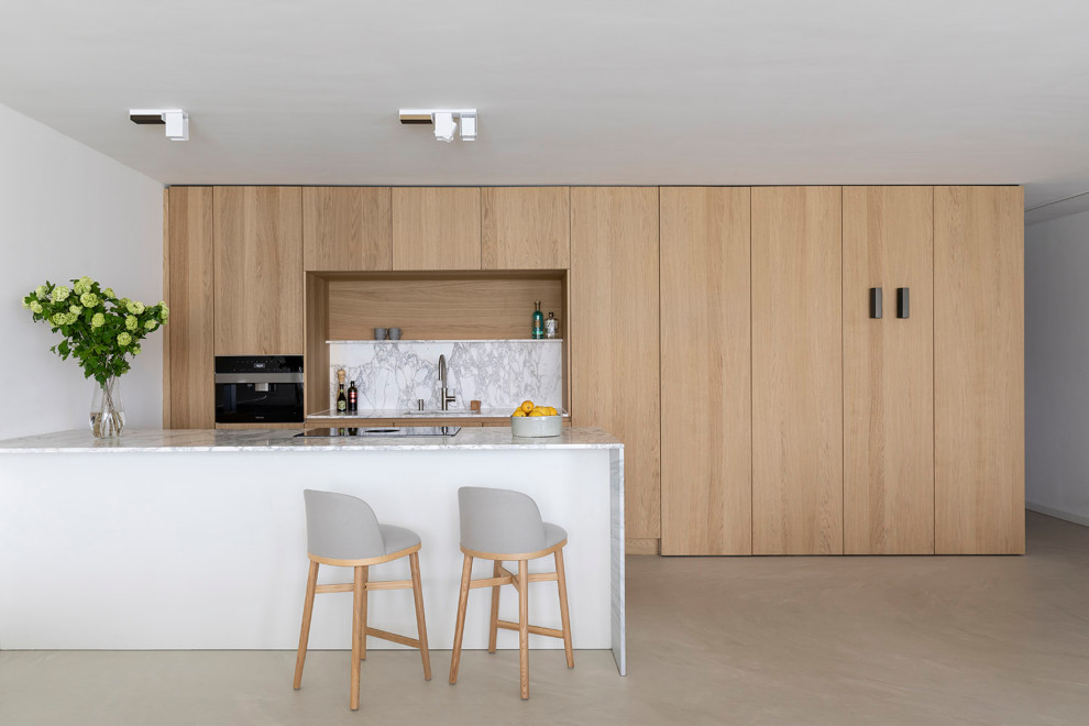 Inspiration for a mid-sized contemporary galley separate kitchen in Melbourne with a drop-in sink, beaded inset cabinets, beige cabinets, marble benchtops, white splashback, marble splashback, stainless steel appliances, medium hardwood floors, with island, beige floor, white benchtop and wallpaper.