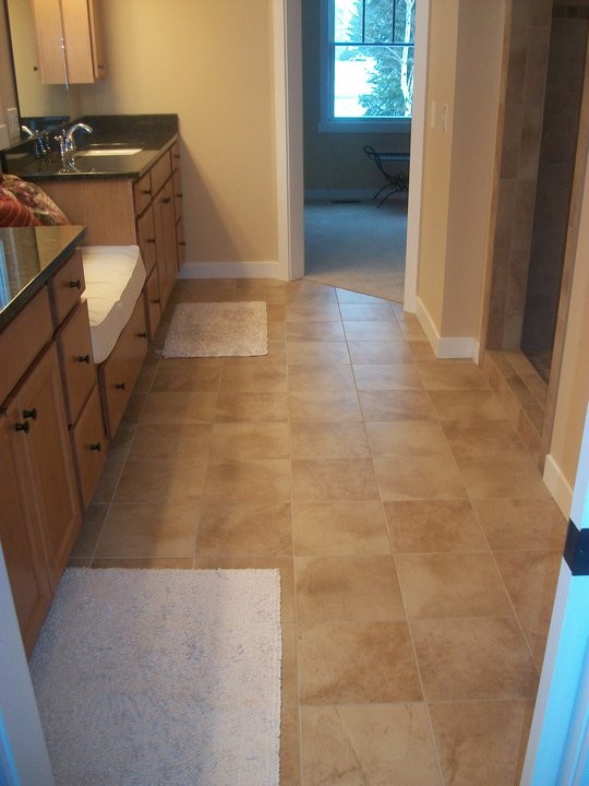 Transitional beige tile alcove shower photo with an undermount sink, medium tone wood cabinets, granite countertops and beige walls