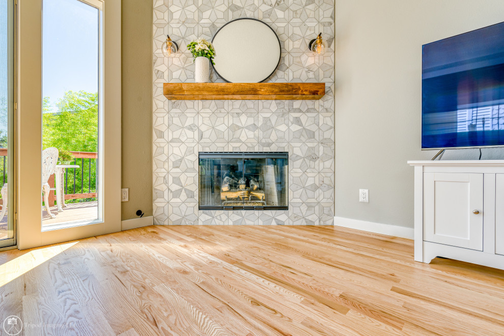 Example of a mid-sized transitional open concept light wood floor, brown floor and tray ceiling living room design in Portland with gray walls, a corner fireplace and a tile fireplace
