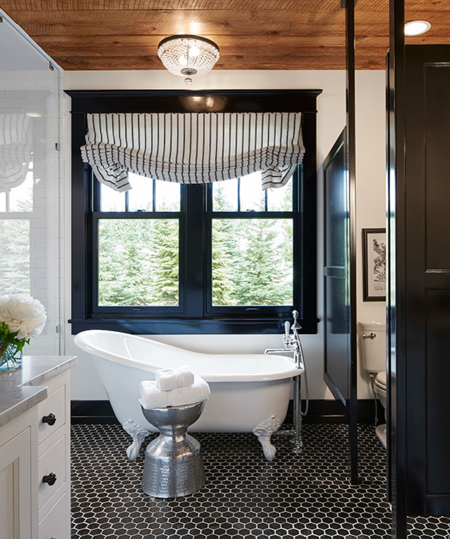Transitional master bathroom in Minneapolis with recessed-panel cabinets, white cabinets, a claw-foot tub, an alcove shower, a two-piece toilet, white tile, subway tile, white walls, ceramic floors, marble benchtops, black floor and a hinged shower door.