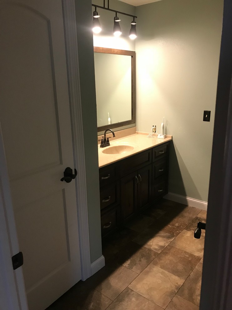 Mid-sized elegant 3/4 ceramic tile and brown floor bathroom photo with onyx countertops, beaded inset cabinets, dark wood cabinets, gray walls and an integrated sink