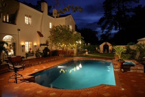 Large transitional backyard stone and rectangular infinity pool photo in Los Angeles