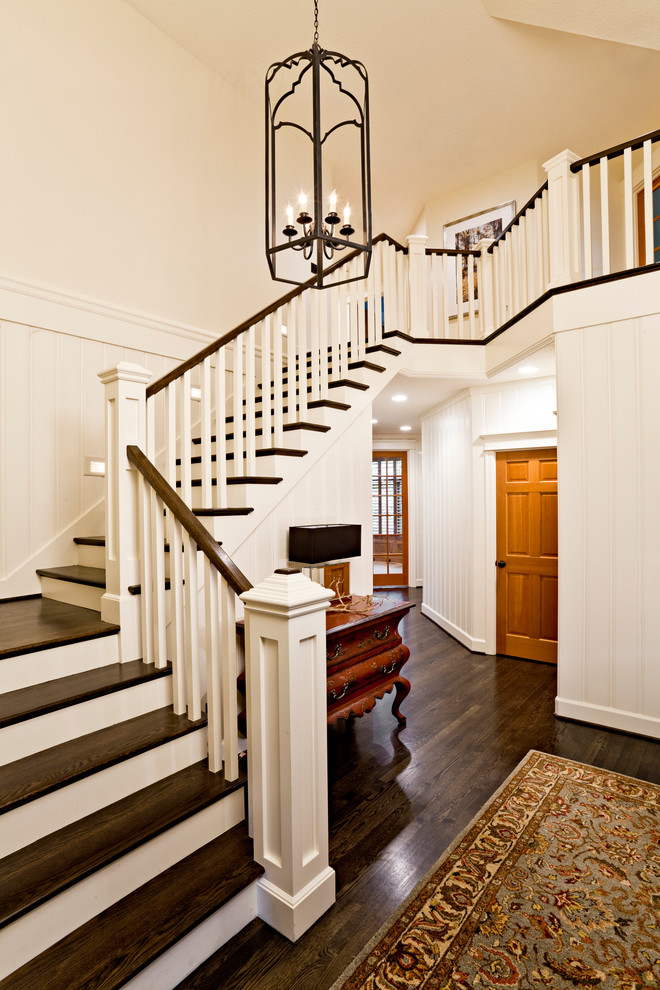 Inspiration for a traditional wood l-shaped staircase in Portland with painted wood risers.