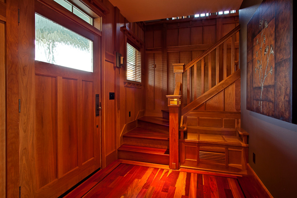 This is an example of an arts and crafts entryway in Portland with a single front door and a medium wood front door.