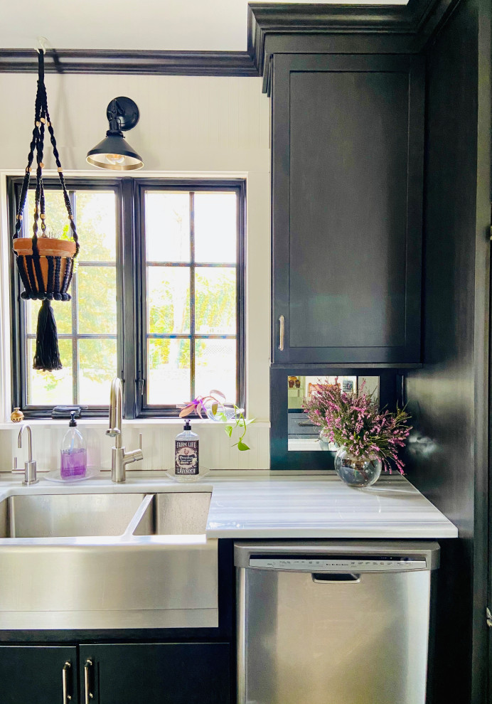 Inspiration for a mid-sized transitional eat-in kitchen in Providence with a farmhouse sink, shaker cabinets, black cabinets, marble benchtops, mirror splashback, stainless steel appliances, cork floors, with island, multi-coloured floor and grey benchtop.