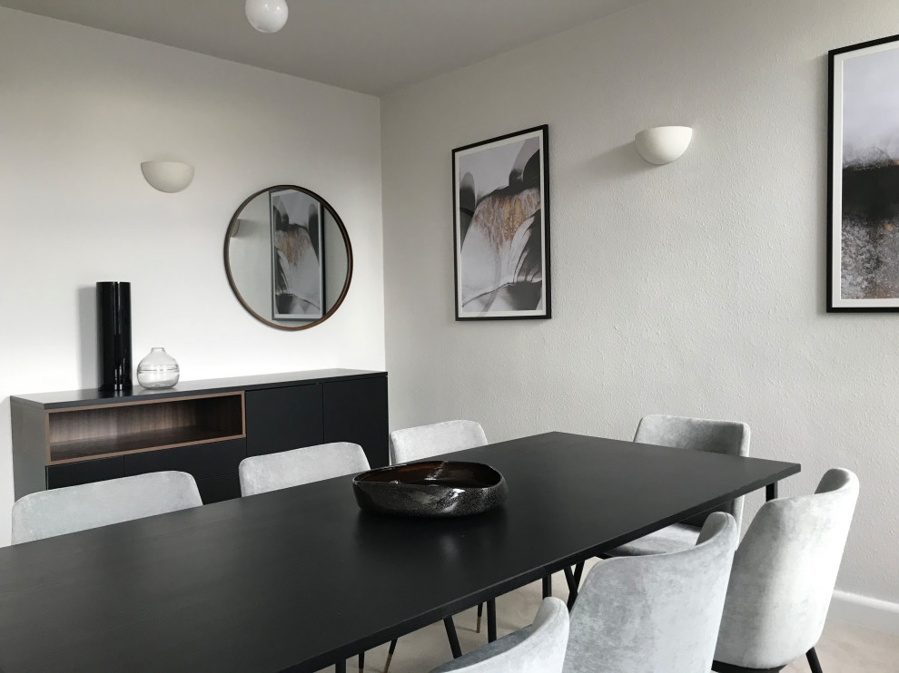 This is an example of a mid-sized contemporary separate dining room in London with beige walls, carpet, no fireplace, beige floor, wallpaper and wallpaper.