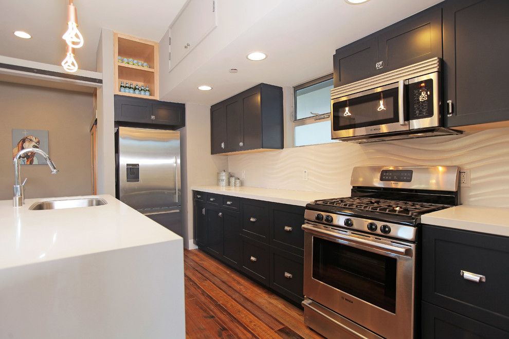 Contemporary single-wall eat-in kitchen in Los Angeles with an undermount sink, shaker cabinets, blue cabinets, quartz benchtops, white splashback, porcelain splashback and stainless steel appliances.